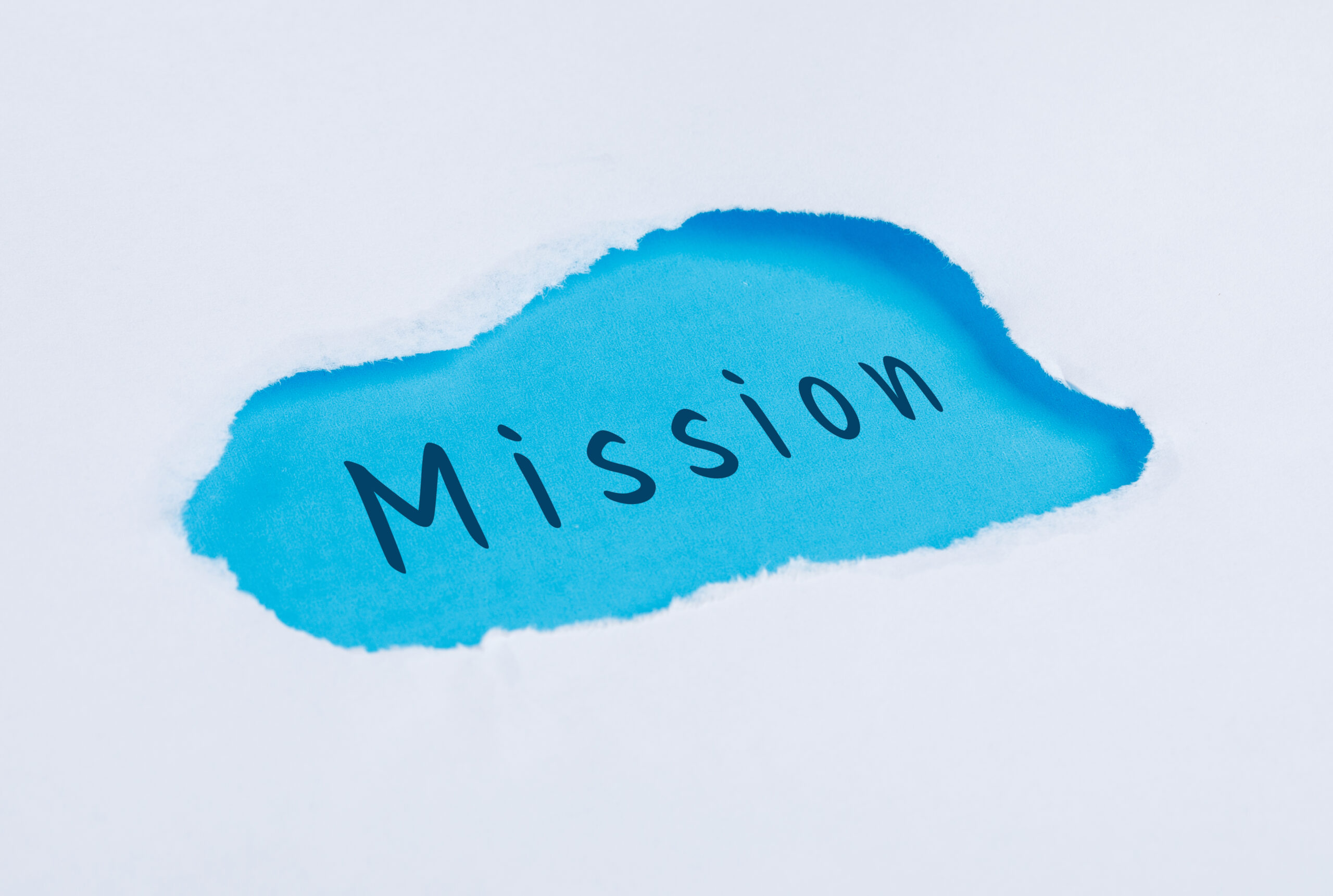 marketing concept with mission word on blue and white background flat lay.